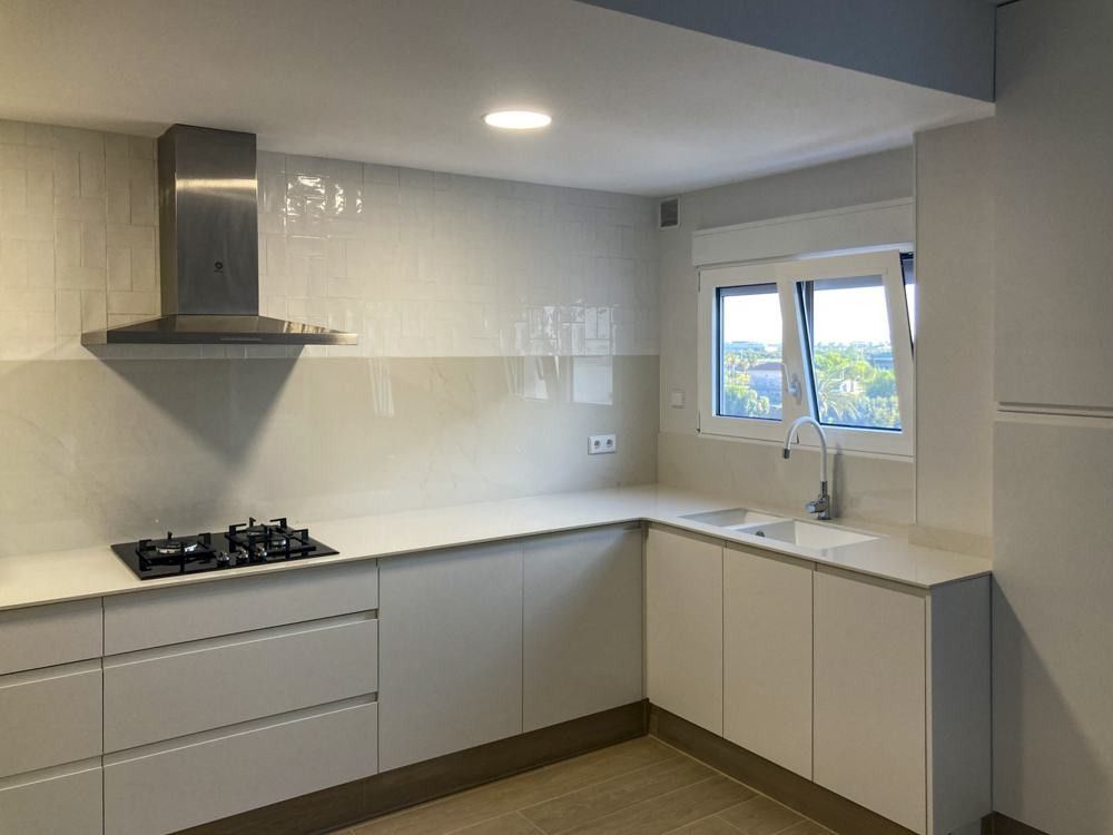 Cocina blanca en L sin muebles altos en un piso de San Isidro