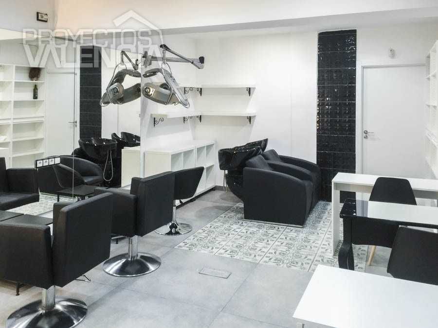 Peluquería en Torrent con sillones negros y alfombra hidráulica blanca y negra