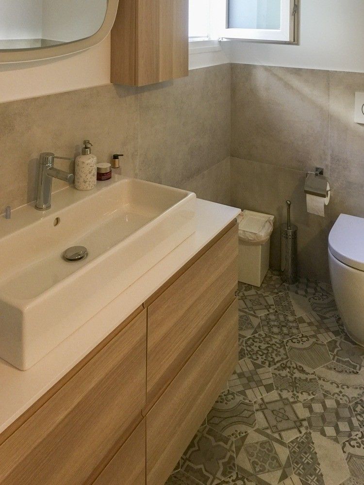 Lavabo rectangular sobre mueble de madera y suelo hidráulico