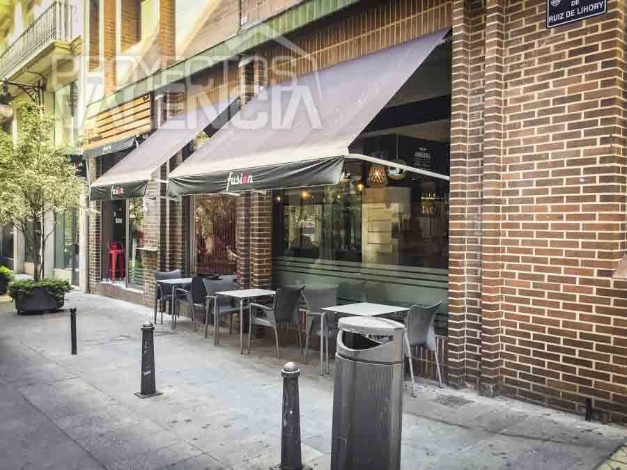 Fachada de ladrillo con toldo y terraza del restaurante en Valencia